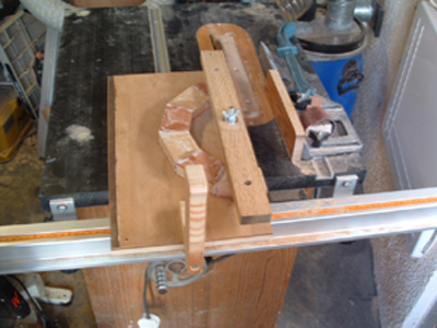 This picture shows a jig which clamps the half circles to cut at the correct angle.
